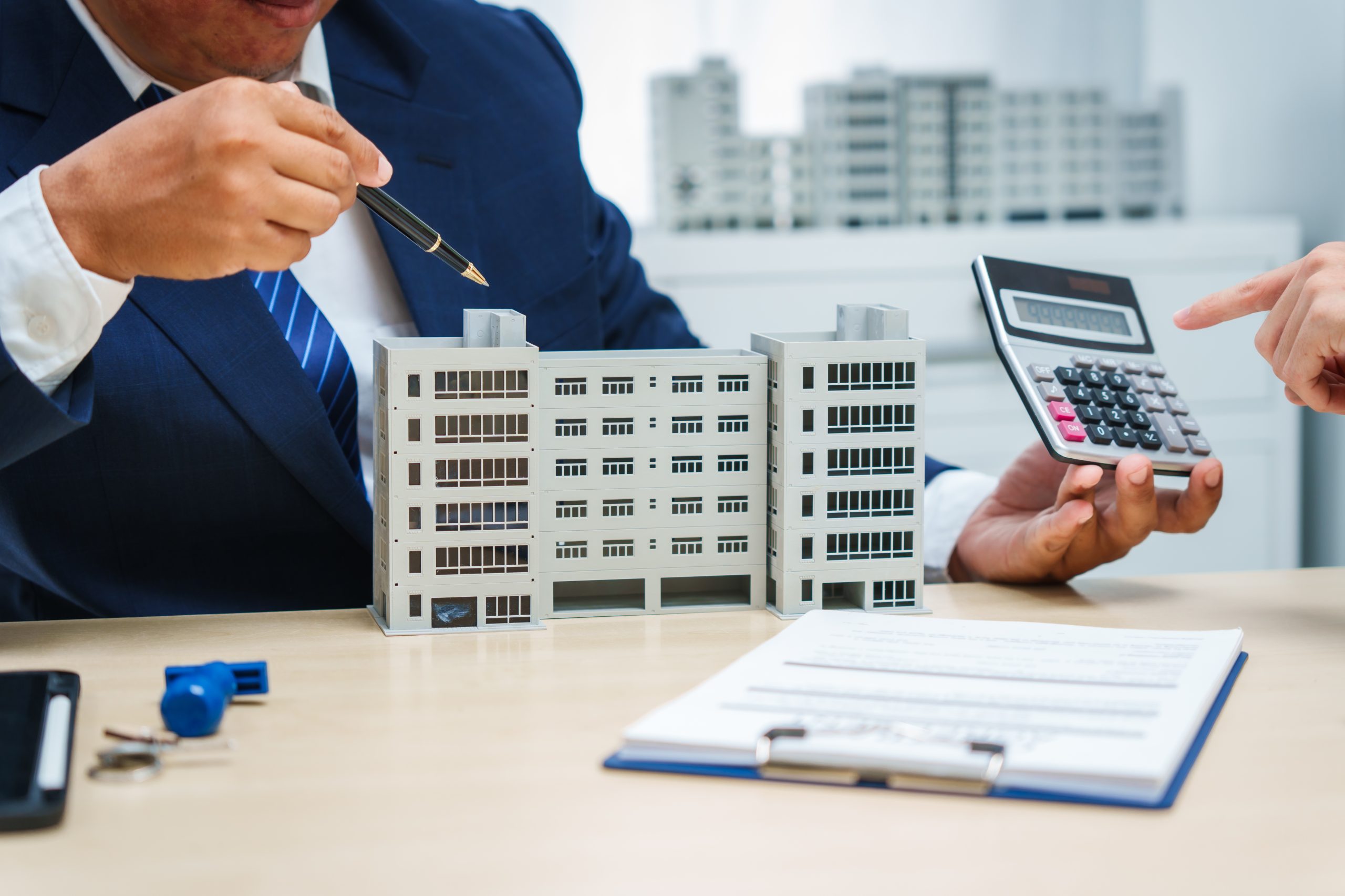 Commercial real estate professionals reviewing financing and investment details for a commercial property.